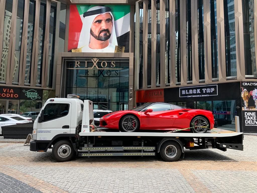 Ferrari sports car recovery on flatbed tow truck in Downtown Dubai - Behram Car Recovery